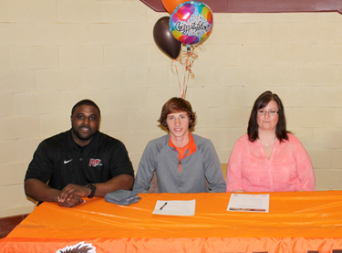 Claymont High School’s Blake Freed poses with his mother, Michelle Gwinn, and Rio Grande assistant track coach Shaun Gunnell